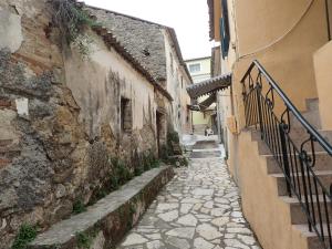 an alley with a stone walkway next to a building at Villa Angelique in Sinarádes