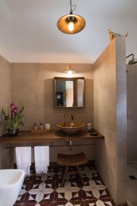 a bathroom with a sink and a mirror at Baglio Giammaccaro in Castelluzzo