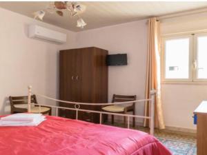 トラーパニにあるAppartamento ad uso Turistico Trapani Oneのベッドルーム1室(ベッド1台、キャビネット、窓付)
