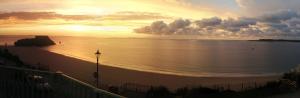 a view of the ocean at sunset from a balcony at Clarence House Hotel in Tenby +66 photos
