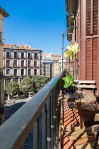 a balcony with a table and flowers on a building at El sitio de Adrian in Madrid