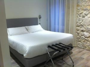 En eller flere senge i et værelse på Hotel de la Couronne