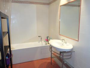 a white bathroom with a sink and a bath tub at Port de Saint-Tropez in Saint-Tropez