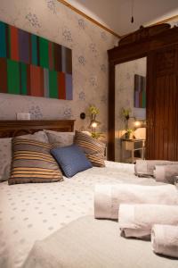 a bedroom with two beds and a colorful wall at El sitio de Adrian in Madrid