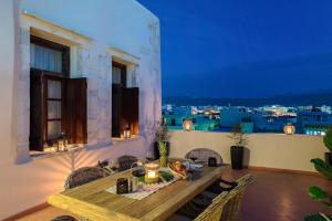 a dining room with a table and a view of the city at Lithinon Luxury Suites Old Town Chania free on-site Parking in Chania +79 photos