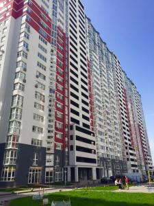 a large apartment building with red and white at East Residence in Kyiv