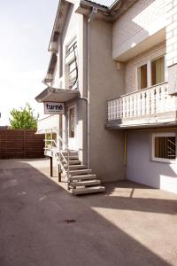 a building with a hotel sign on the side of it at Turnė Guest House in Šiauliai