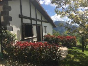 a house with red flowers in front of it at Casa Rural Balerdi in Azcárate