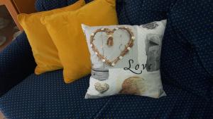 a pillow with a heart and the word love on it at Garden apartment Vanya in Split