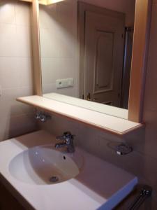een badkamer met een wastafel en een spiegel bij Schuster Emma in Valdaora