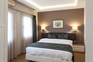 a bedroom with a large bed and a window at Sun Garden Apart Hotel in Yalıkavak