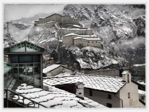 una foto en blanco y negro de un pueblo en una montaña en Hotel Ad Gallias en Bard