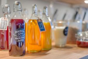 a group of bottles of drinks on a wooden table at Dream Hostel & Hotel Tampere in Tampere