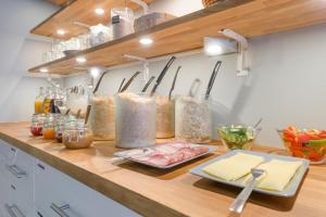 a kitchen counter with many containers of food on it at Dream Hostel & Hotel Tampere in Tampere