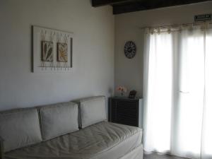 a living room with a couch and a clock on the wall at Morada al Sur in Dina Huapi