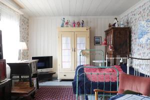 a bedroom with a bed and a tv in it at 1800's Townhouse in Loviisa