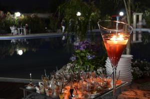 a table with a wine glass and a tray of food at Alessidamo Club Metaponto in Metaponto