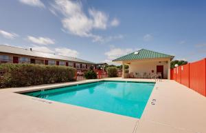 a swimming pool in front of a building at Days Inn by Wyndham San Angelo in San Angelo
