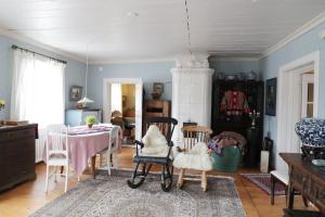 a living room with a table and chairs at 1800's Townhouse in Loviisa
