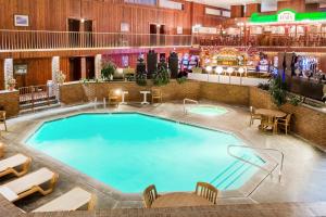 a pool in the lobby of a hotel at Ramada by Wyndham Ely in Ely