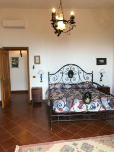 a bedroom with a bed and a chandelier at La Casa Del Nonno Raffaele- Country house in Ravello