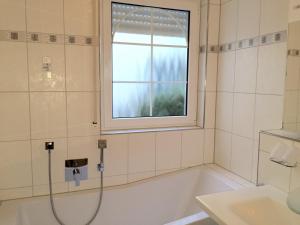 a bathroom with a bath tub and a window at Symphonie-Villa am See - Musikerviertel in Konstanz