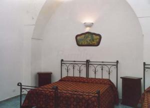 Кровать или кровати в номере Oasi Rupestre