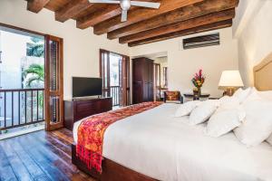 A bed or beds in a room at Ananda Hotel Boutique
