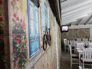 a bicycle on the side of a wall in a restaurant at Hotel Fantasy in Lyubimets