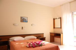 a bedroom with a bed with flowers on it at Aktio Studios in Gavrion