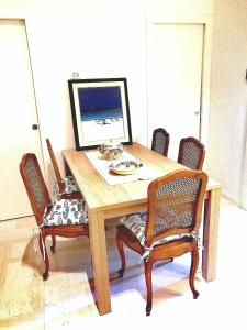 a wooden table with chairs and a computer on it at Venticello Apartment in Bari