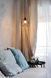 a chandelier hanging over a bed next to a window at Apartment Albufereta beach in Alicante