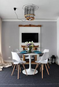 a dining room with a table and white chairs at Apartment Albufereta beach in Alicante