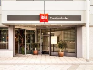 a building with a sign on the front of it at Ibis Madrid Alcobendas in Alcobendas