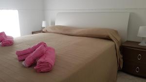 レイタニにあるVilla Gaiaのベッドルーム1室(ピンクのタオルが付いたベッド1台付)