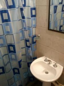 baño con lavabo y cortina de ducha en Departamento Alvarado en Salta