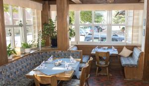 a restaurant with two tables and chairs and windows at Hotel Restaurant Lütkebohmert in Reken