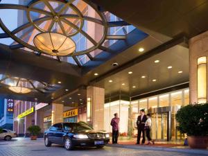 a car parked in front of a shopping center at Grand Mercure Beijing Central in Beijing