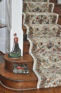 a figurine of a woman riding a train on a staircase at My Rosegarden Guest Rooms in San Francisco