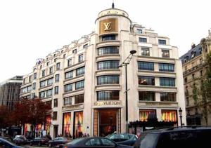 a large white building with a clock on top of it at Private Studio - Avenue des Champs-Elysées in Paris