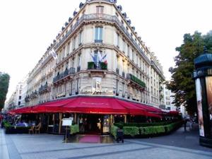 a large building with a red umbrella in front of it at Private Studio - Avenue des Champs-Elysées in Paris