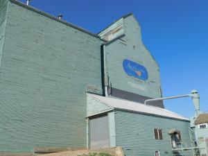 a blue building with a sign on the side of it at Cedar Villa Motel in Foremost