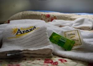 a pile of towels on top of a bed at Pousada Araxá in Araxá +53 photos