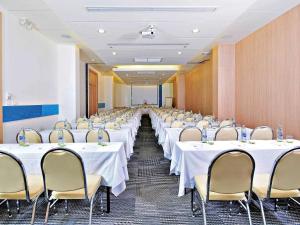 a conference room with white tables and chairs in it at Ibis Phuket Kata in Kata Beach