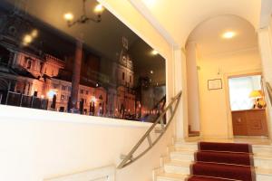 a reflection of buildings in a window of a building at Hotel Kent in Rome