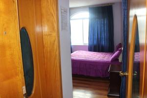 Postel nebo postele na pokoji v ubytování Hostal Mirador de Otavalo