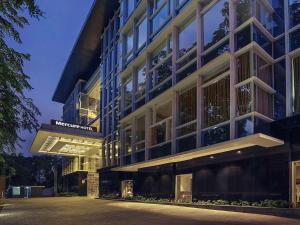 a building with a sign on the side of it at Mercure Jakarta Sabang in Jakarta