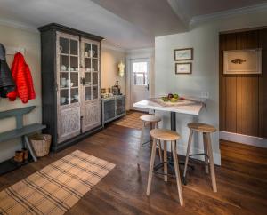 a kitchen with a table and stools in a room at Dunton Town House Hotel in Telluride