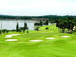a view of a golf course with a lake at Orchid Country Club in Singapore