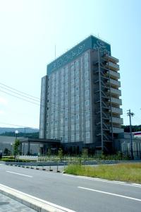 a large building on the side of a road at Hotel Route-Inn Ena in Ena